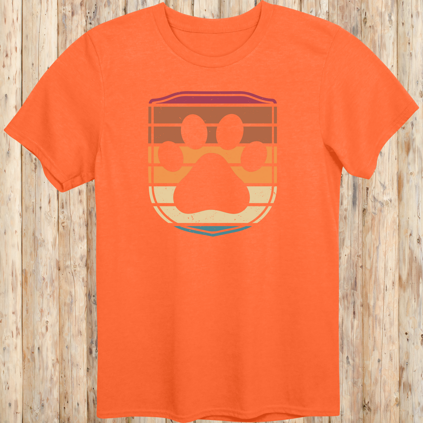 Unisex orange t-shirt featuring a retro-style dog paw print inside a colorful shield graphic, designed for dog lovers