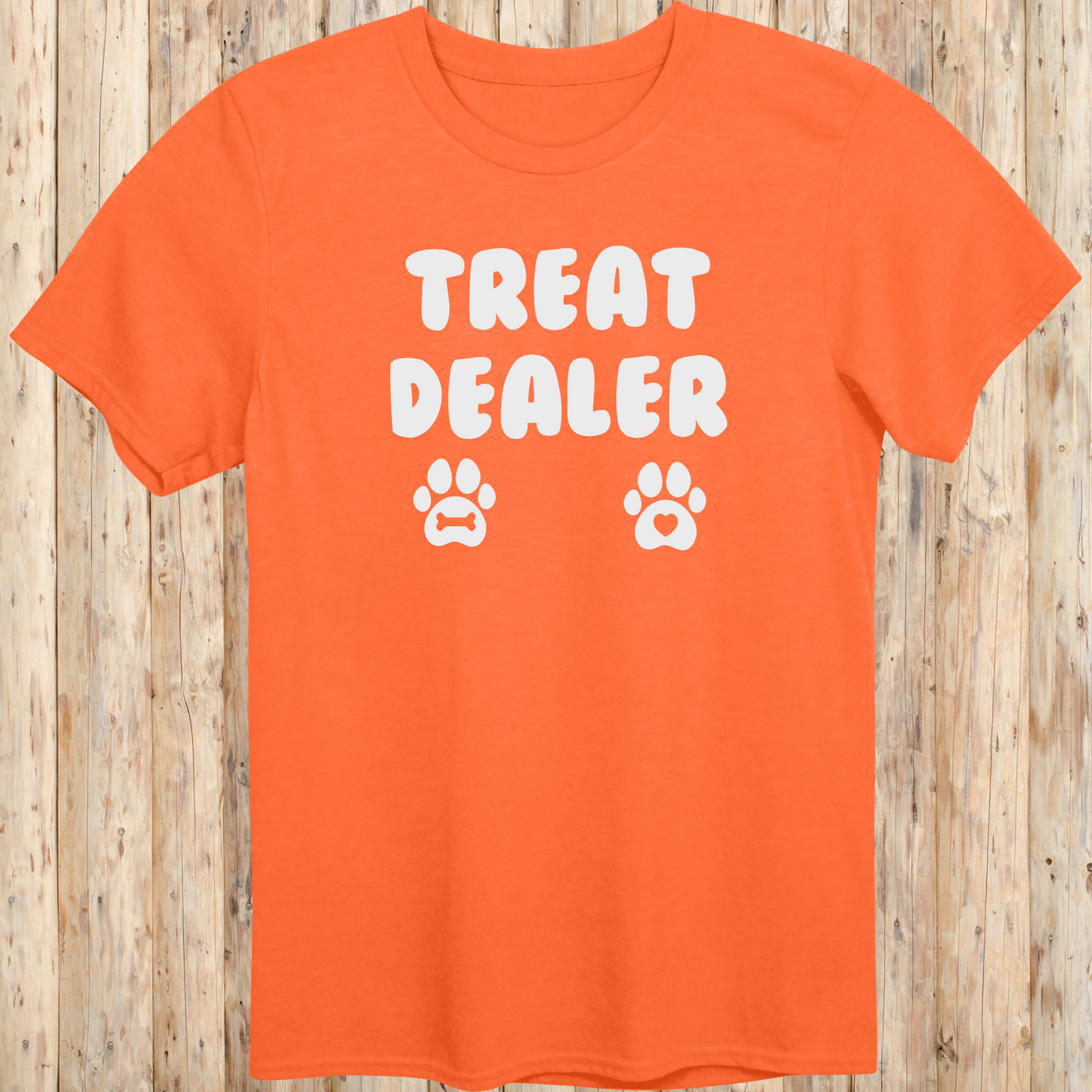 Orange unisex t-shirt for men and women says Treat Dealer and has 2 paw prints.