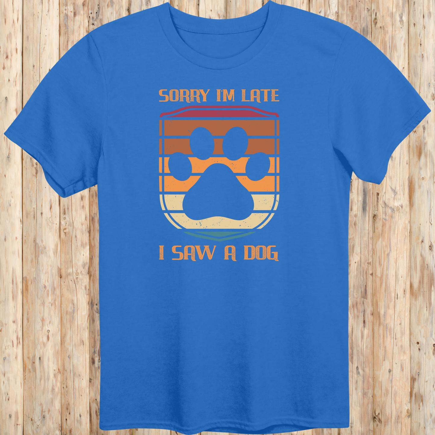 Royal blue unisex t-shirt with retro-colored paw print shield and the phrase 'Sorry I’m Late, I Saw a Dog', perfect for dog lovers