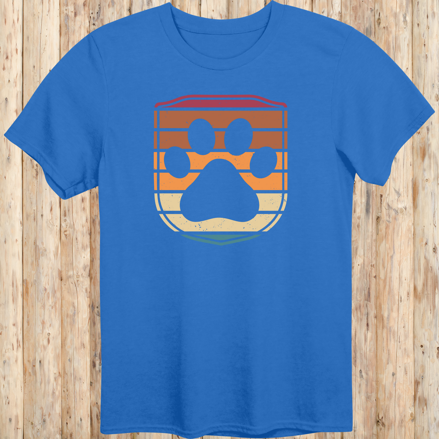Unisex royal blue t-shirt featuring a retro-style dog paw print inside a colorful shield graphic, designed for dog lovers