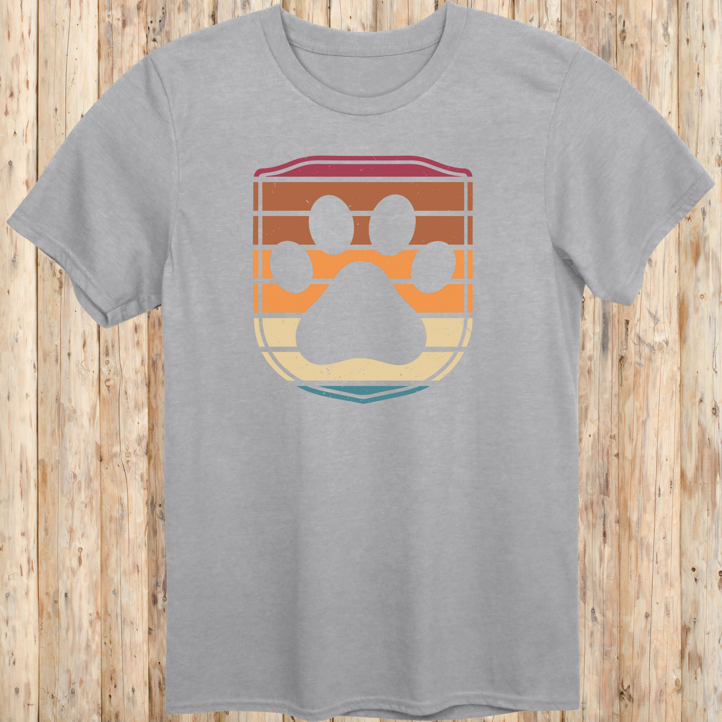 Unisex sport grey t-shirt featuring a retro-style dog paw print inside a colorful shield graphic, designed for dog lovers