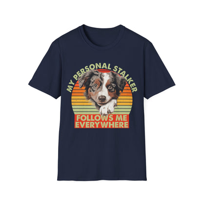 Navy blue unisex t-shirt Australian Shepherd with retro sunset and text that says 'My Personal Stalker Follows Me Everywhere', ideal for Aussie owners and dog lovers with Velcro dogs
