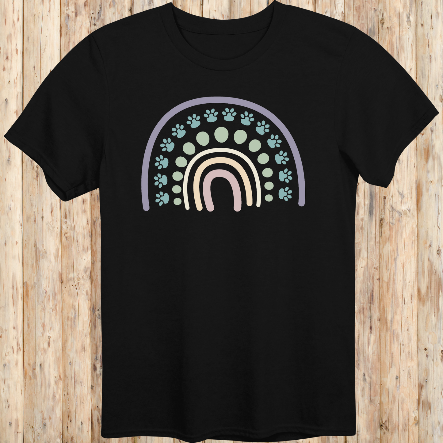 Black unisex t-shirt with a colorful boho rainbow and white dog paw print design, ideal for dog lovers and pet parents with a boho style