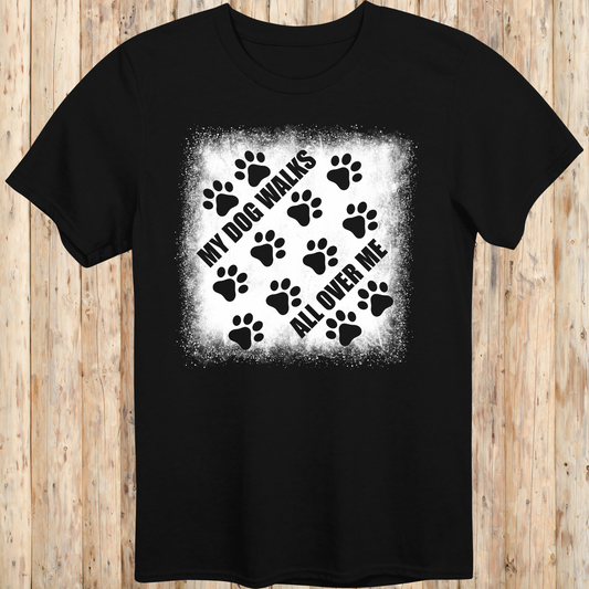 Black unisex t-shirt with paw prints and the phrase 'My Dog Walks All Over Me' printed on the front for men women adults and humans.