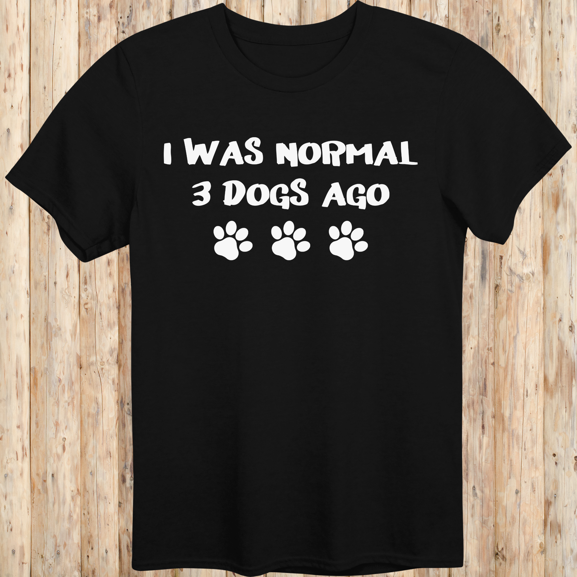 Black unisex t-shirt with text that says 'I Was Normal 3 Dogs Ago', ideal for dog lovers and multiple pet owners