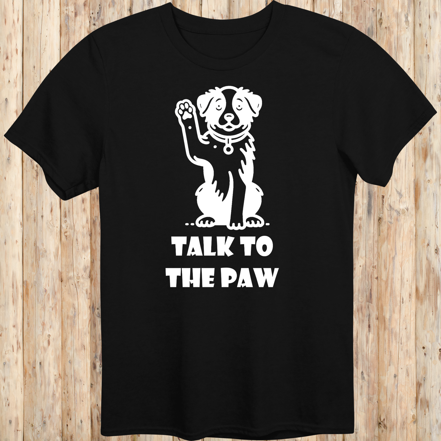 Black unisex t-shirt with text that says 'Talk to the Paw', ideal for dog lovers and pet parents with a fun, sassy style