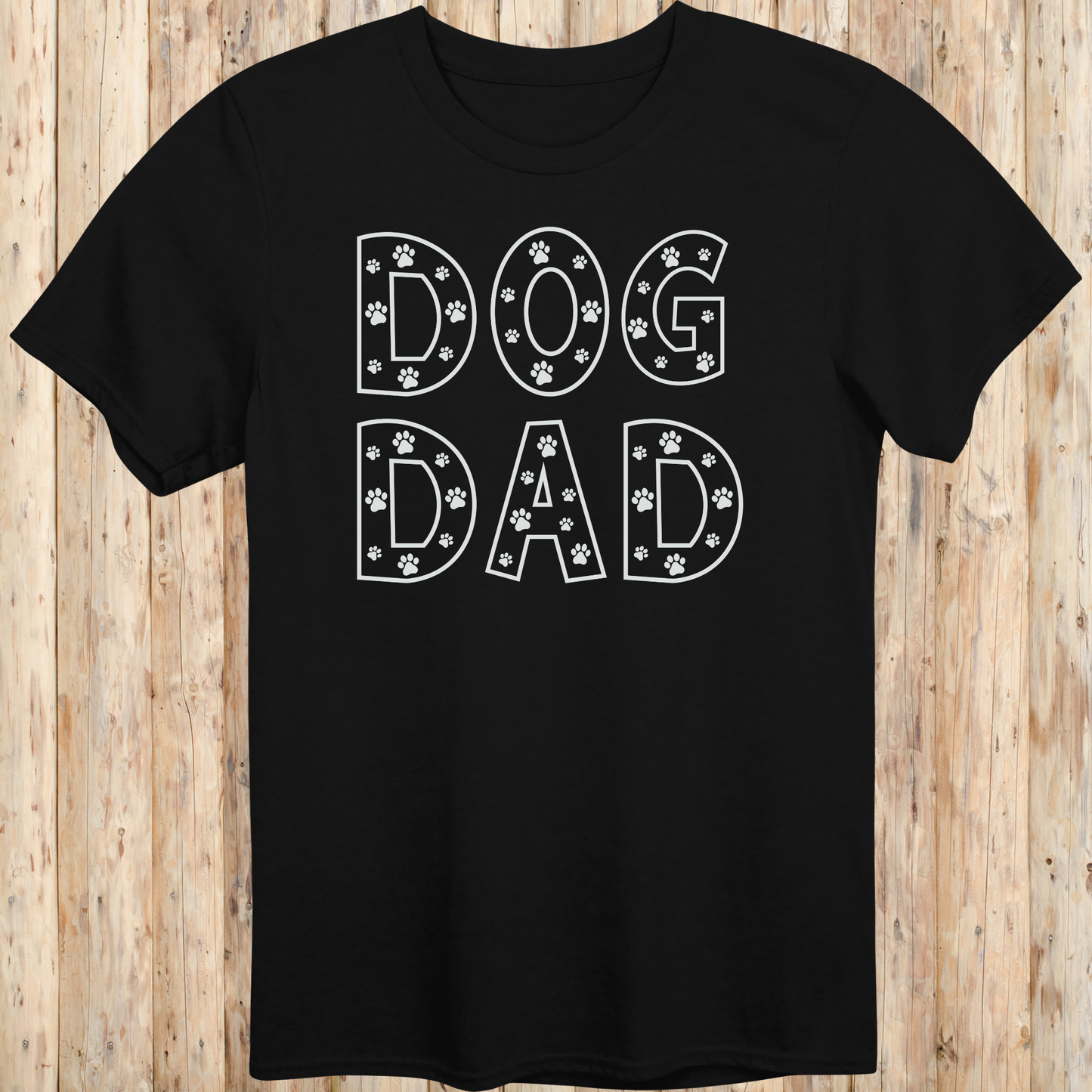 Black unisex t-shirt with the words 'Dog Dad' in white text and small paw print accents, perfect for dog dads and pet owners