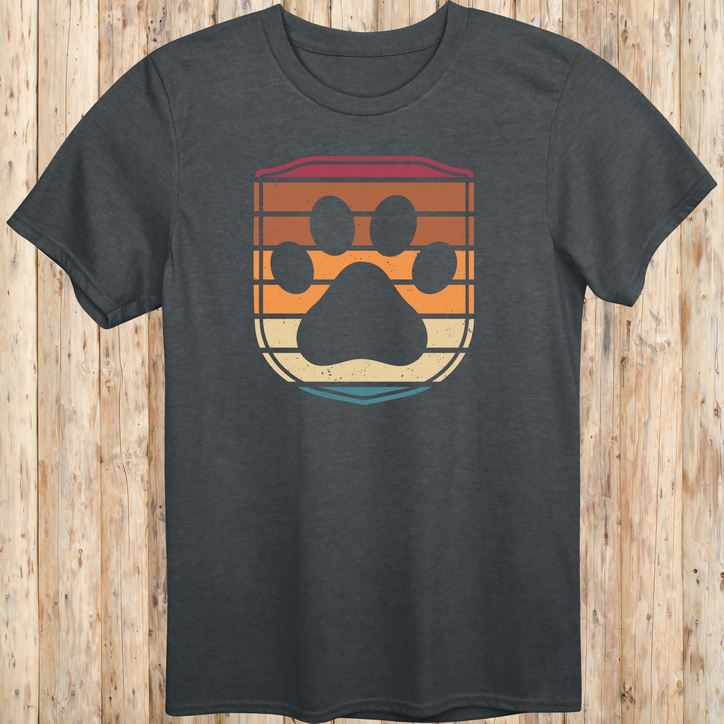 Unisex dark heather t-shirt featuring a retro-style dog paw print inside a colorful shield graphic, designed for dog lovers