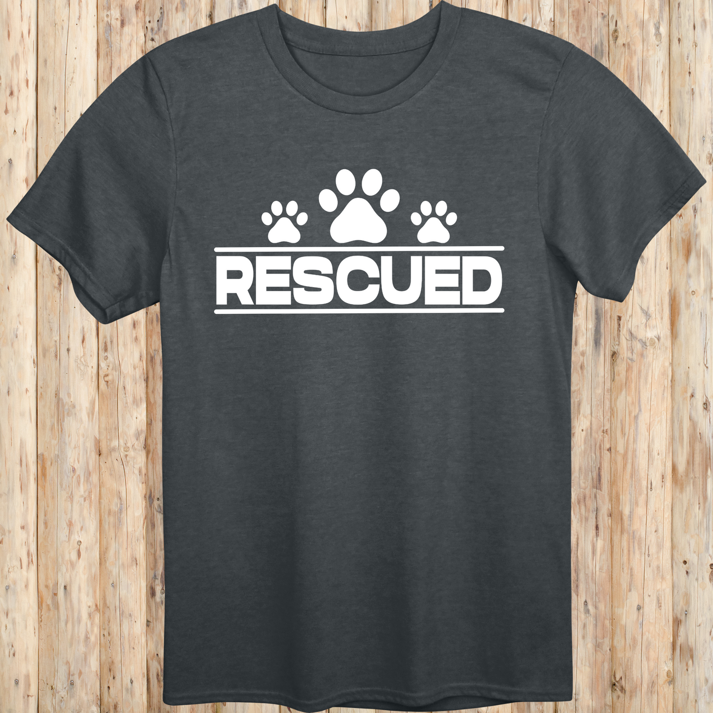 Dark heather unisex t-shirt with text that reads 'Rescued', ideal for rescue dog adopters and animal welfare supporters