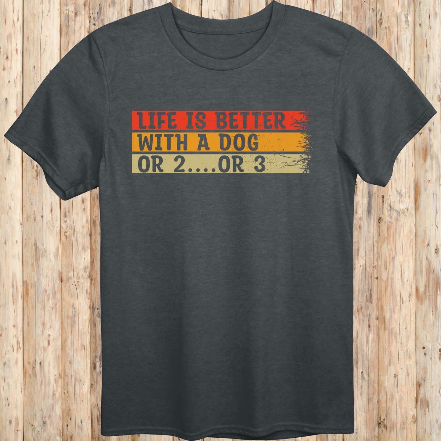 Dark heather unisex t-shirt with text that reads 'Life Is Better With a Dog… or 2 or 3', perfect for multi-dog owners and pet lovers