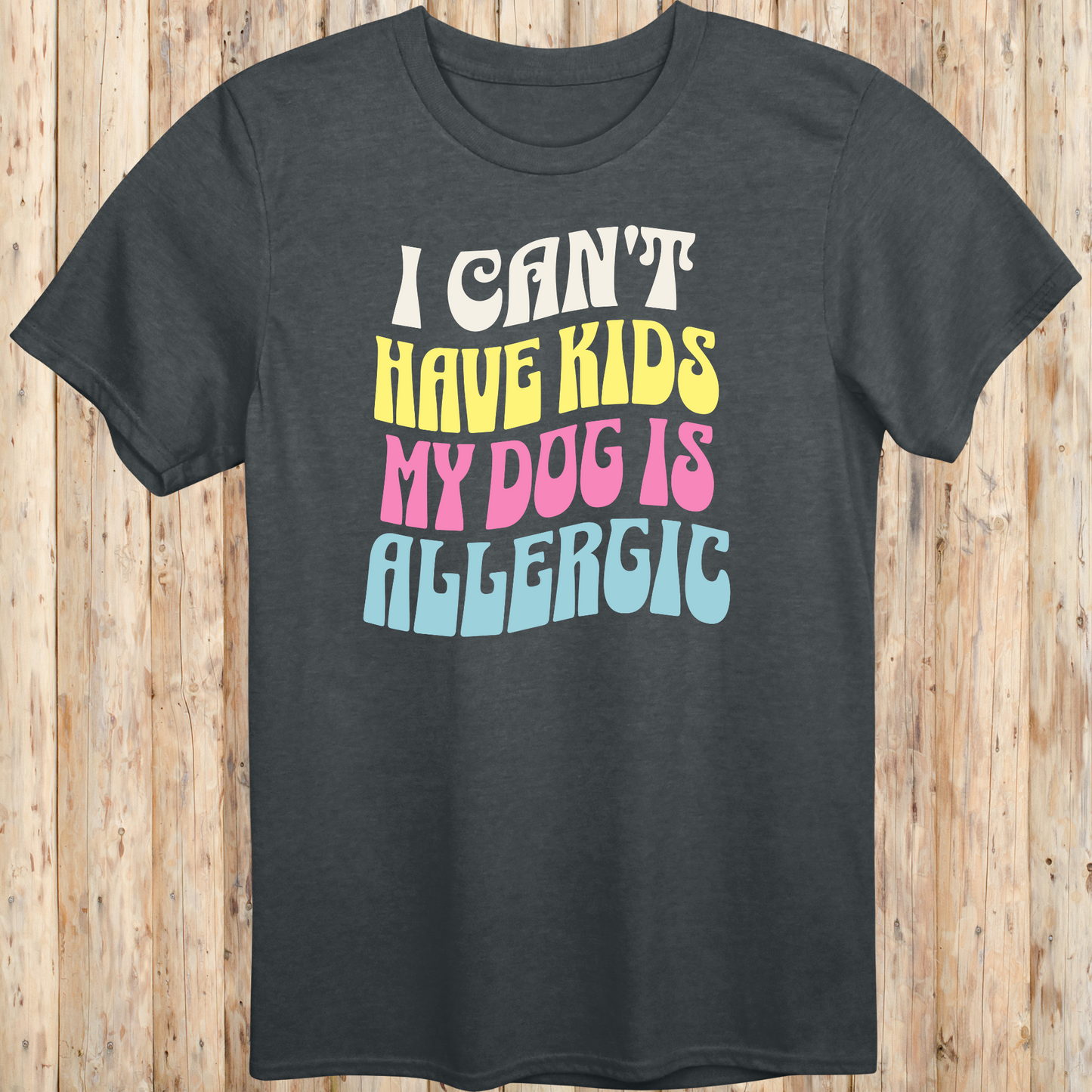 Dark heather unisex t-shirt with white text that says 'I Can’t Have Kids, My Dog Is Allergic', designed for dog lovers with a funny side