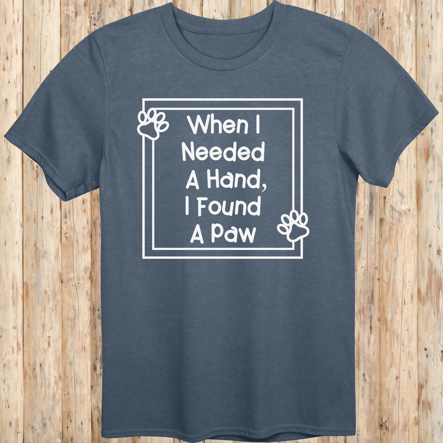 Heather indigo unisex t-shirt with text that reads 'When I Needed a Hand I Found a Paw', ideal for dog lovers and rescue pet adopters