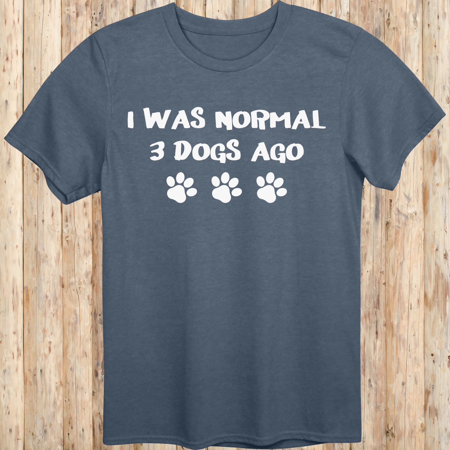 Heather indigo unisex t-shirt with text that says 'I Was Normal 3 Dogs Ago', ideal for dog lovers and multiple pet owners