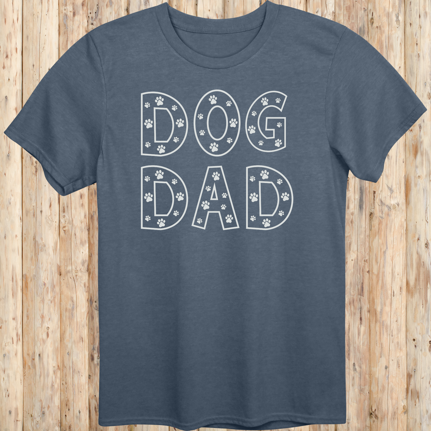 Heather indigo unisex t-shirt with the words 'Dog Dad' in white text and small paw print accents, perfect for dog dads and pet owners