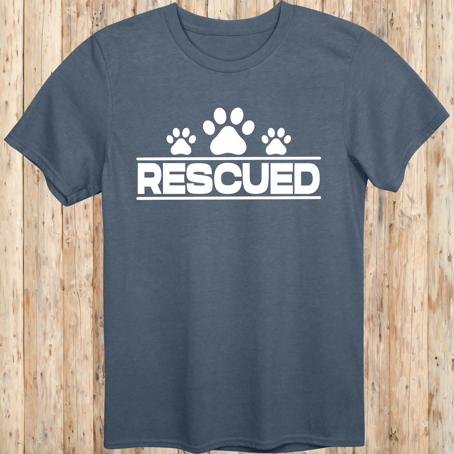 Heather indigo unisex t-shirt with text that reads 'Rescued', ideal for rescue dog adopters and animal welfare supporters