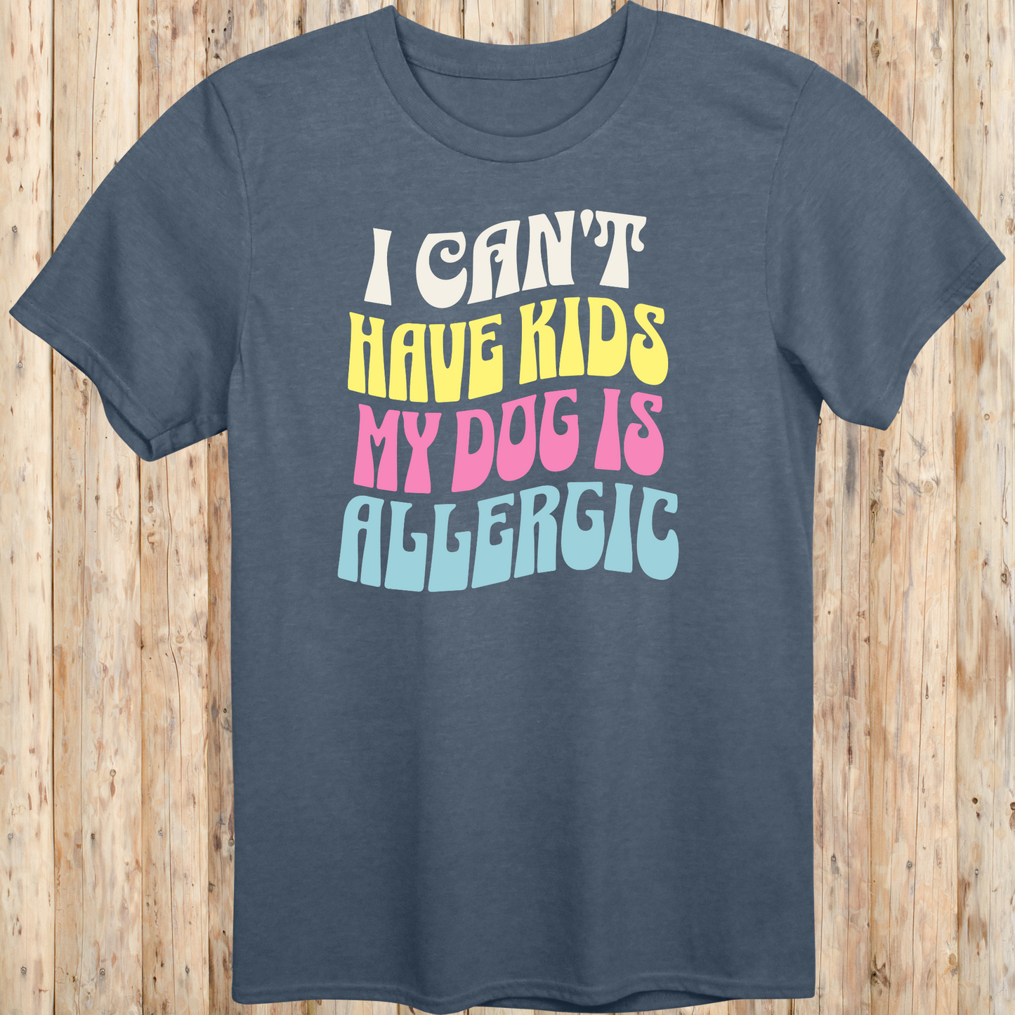 Heather indigo unisex t-shirt with white text that says 'I Can’t Have Kids, My Dog Is Allergic', designed for dog lovers with a funny side