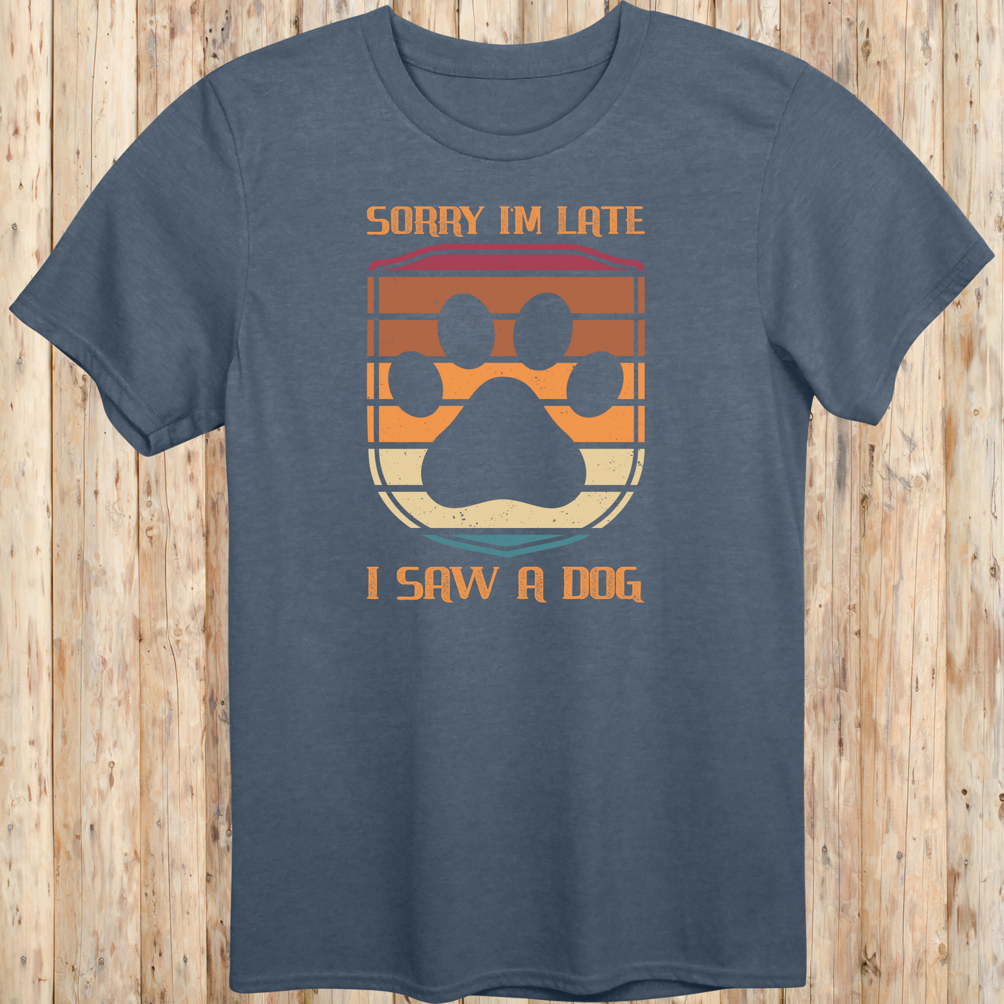 Heather indigo unisex t-shirt with retro-colored paw print shield and the phrase 'Sorry I’m Late, I Saw a Dog', perfect for dog lovers