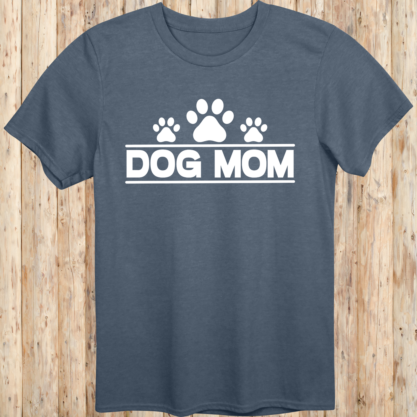 Heather indigo unisex t-shirt with bold text that reads 'Dog Mom', ideal for pet parents, dog lovers, and animal rescue supporters