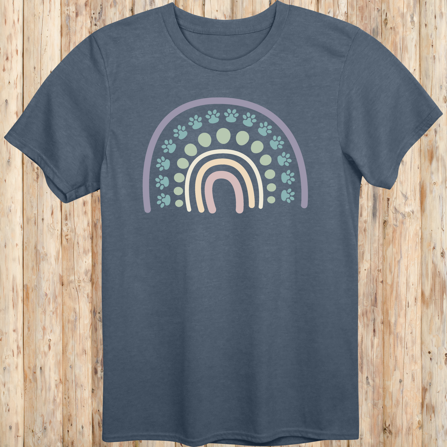Heather indigo unisex t-shirt with a colorful boho rainbow and white dog paw print design, ideal for dog lovers and pet parents with a boho style