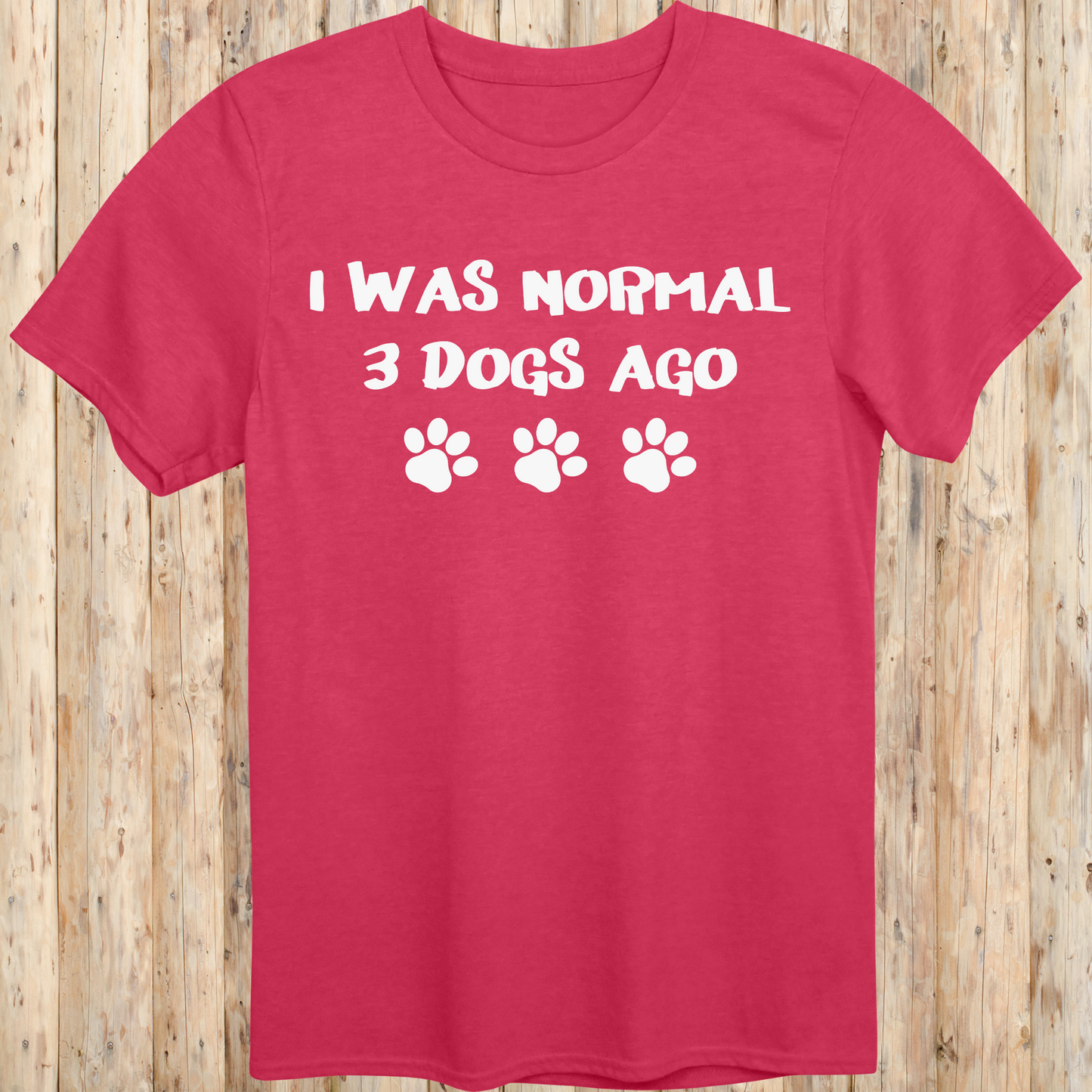 Heather red unisex t-shirt with text that says 'I Was Normal 3 Dogs Ago', ideal for dog lovers and multiple pet owners