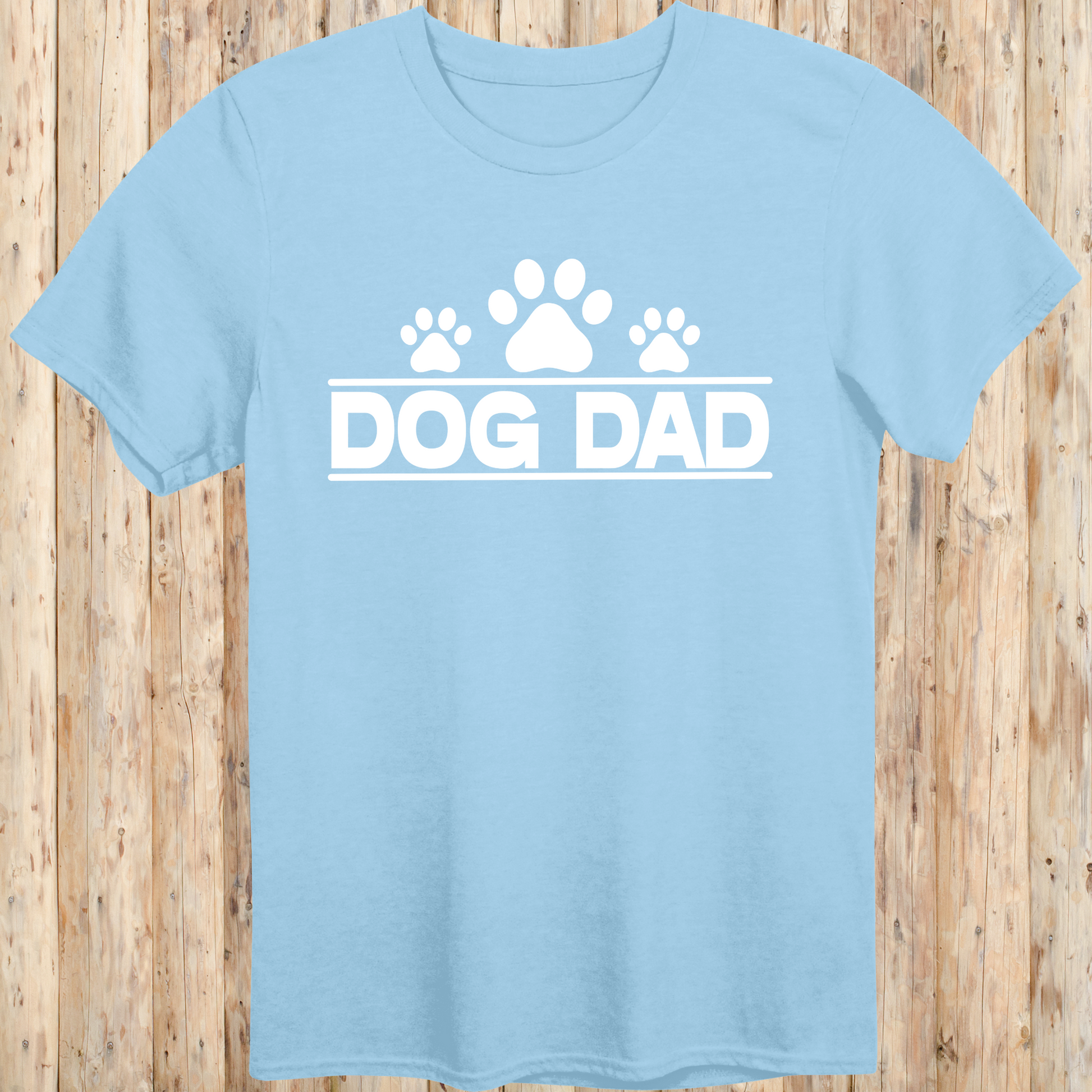 Light blue unisex t-shirt with bold text that says 'Dog Dad', perfect for fathers, pet owners, and dog lovers