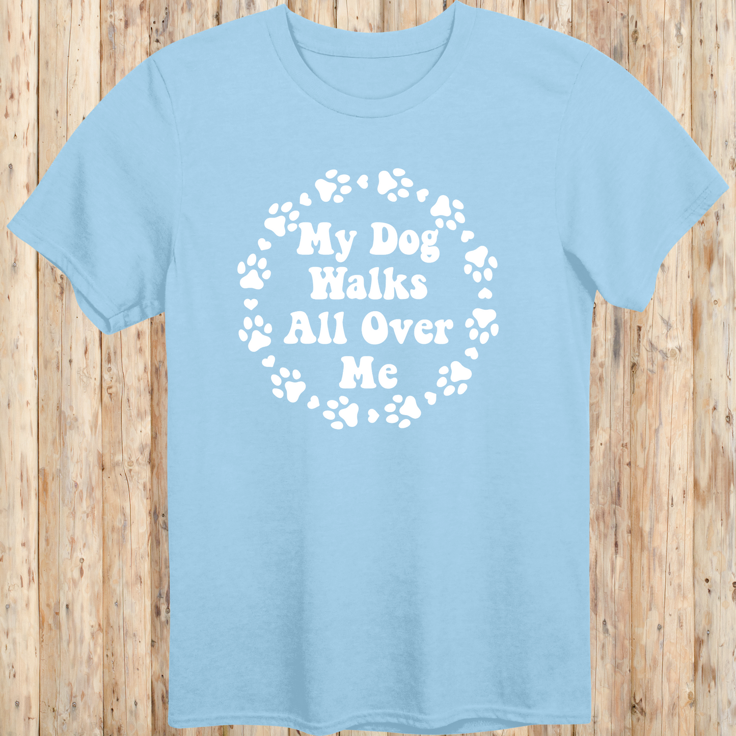 unisex light blue t-shirt for dog lovers says my dog walks all over me paw prints circle