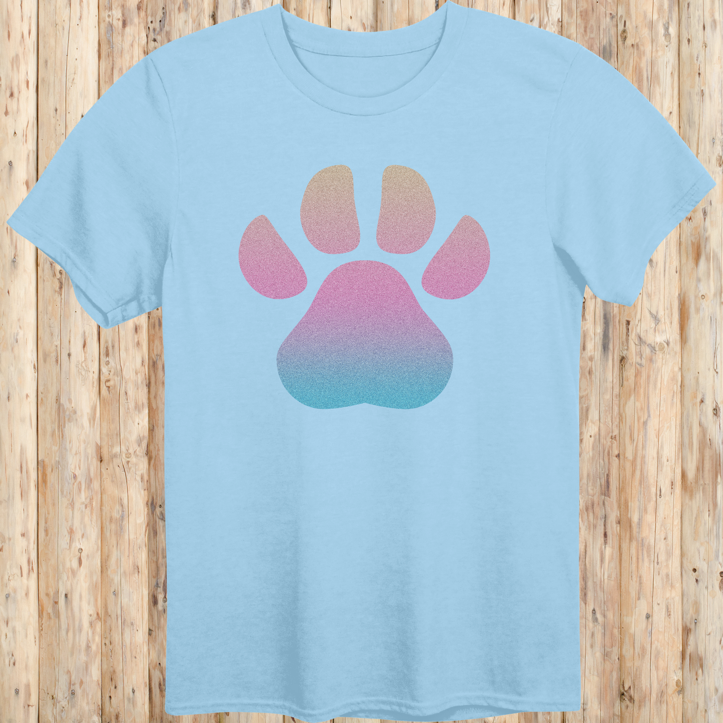 Light blue unisex t-shirt with a large, colorful dog paw print design on the front, ideal for dog lovers and pet enthusiasts