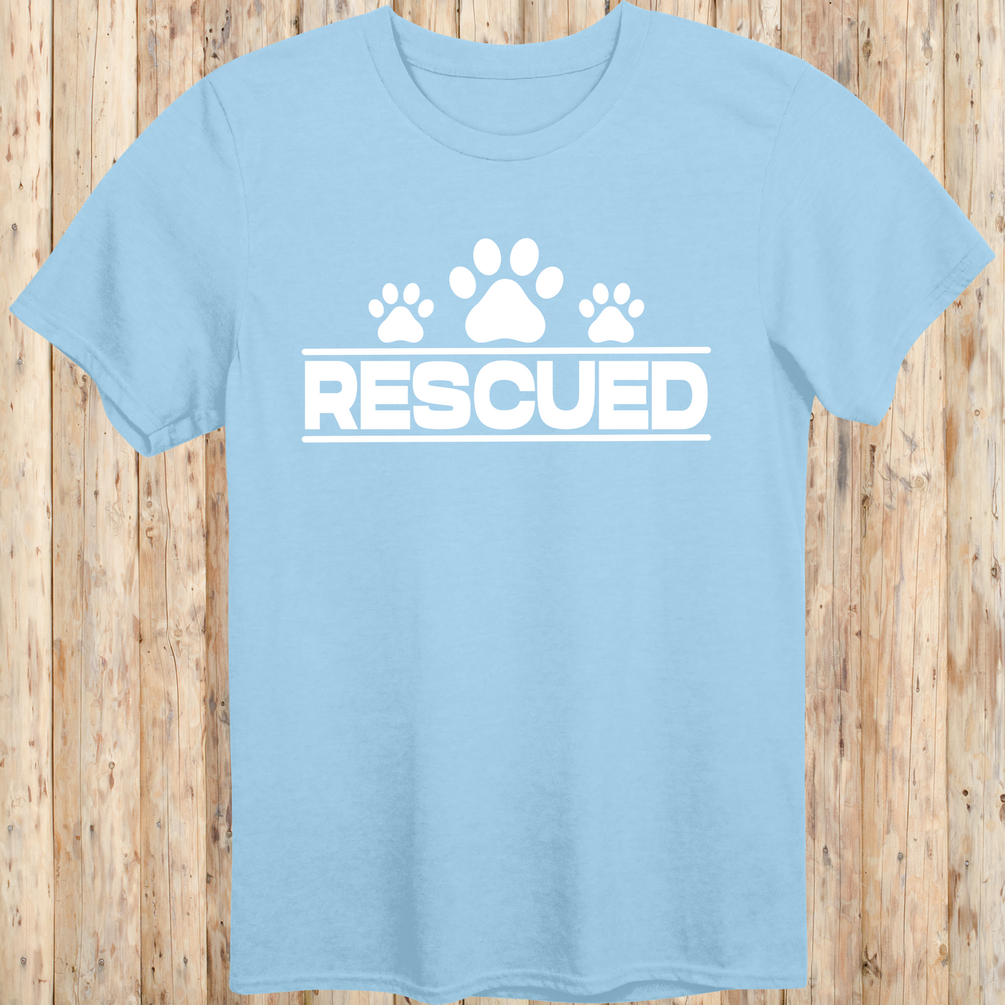 Light blue unisex t-shirt with text that reads 'Rescued', ideal for rescue dog adopters and animal welfare supporters