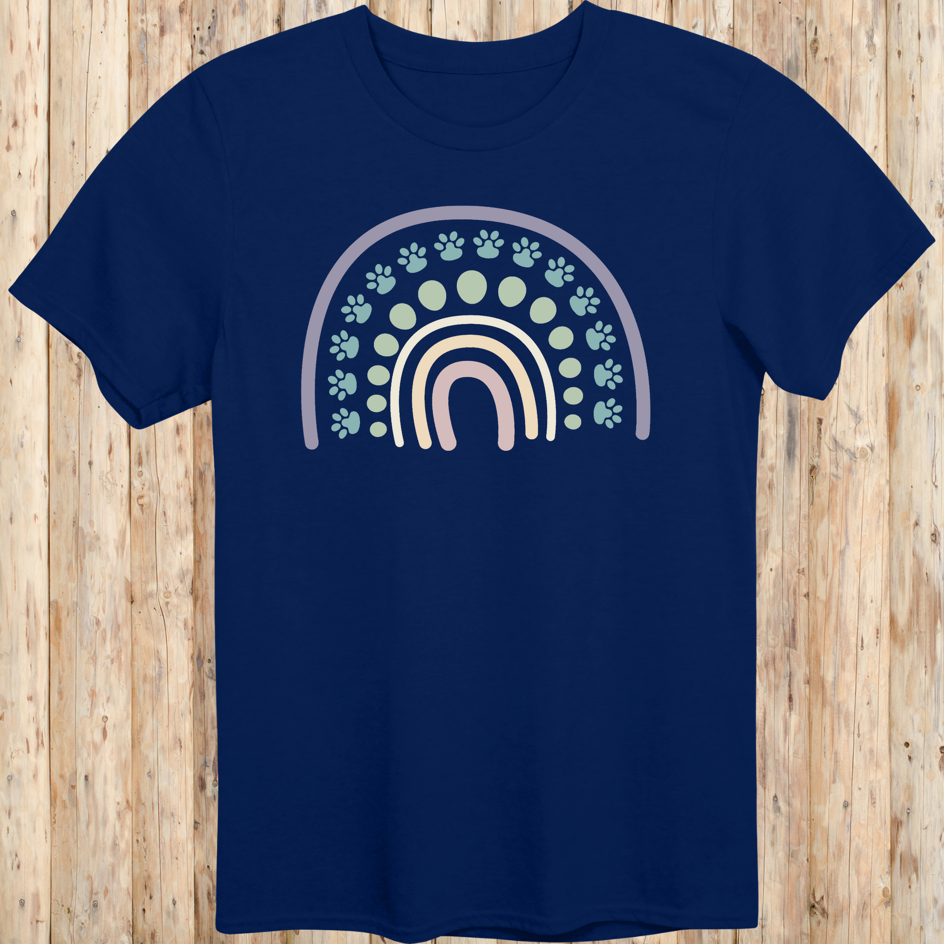 Navy blue unisex t-shirt with a colorful boho rainbow and white dog paw print design, ideal for dog lovers and pet parents with a boho style