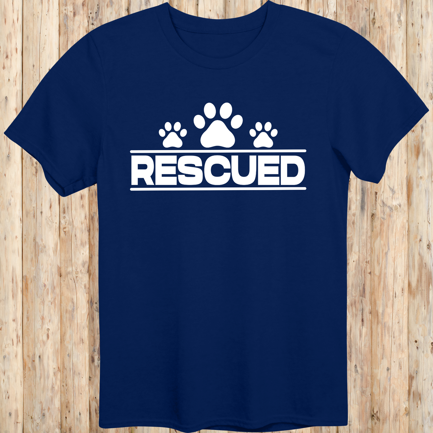 Navy blue unisex t-shirt with text that reads 'Rescued', ideal for rescue dog adopters and animal welfare supporters
