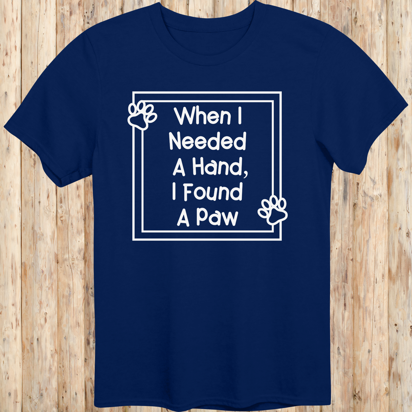 Navy blue unisex t-shirt with text that reads 'When I Needed a Hand I Found a Paw', ideal for dog lovers and rescue pet adopters