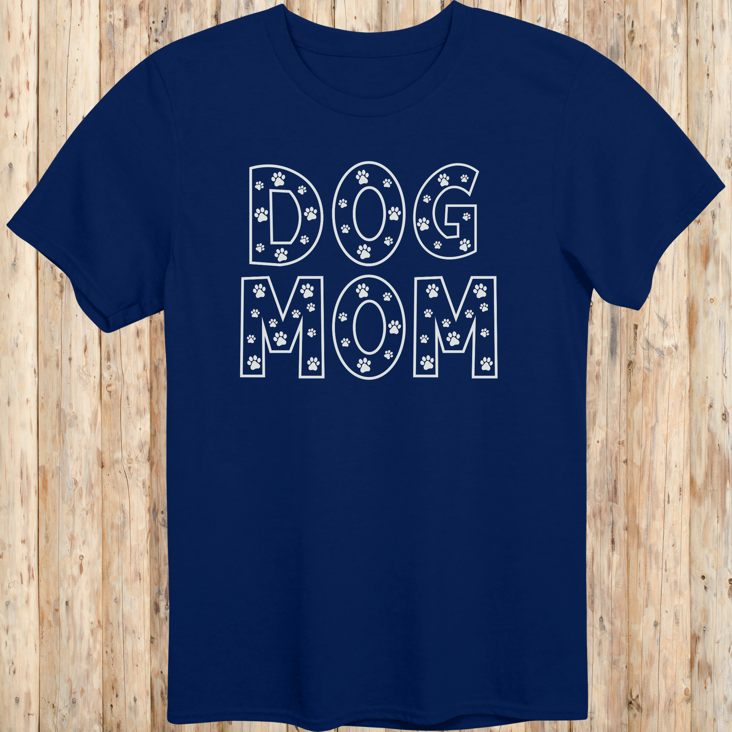Navy blue unisex t-shirt with the words 'Dog Mom' in white text and small paw print accents, ideal for pet moms and dog lovers