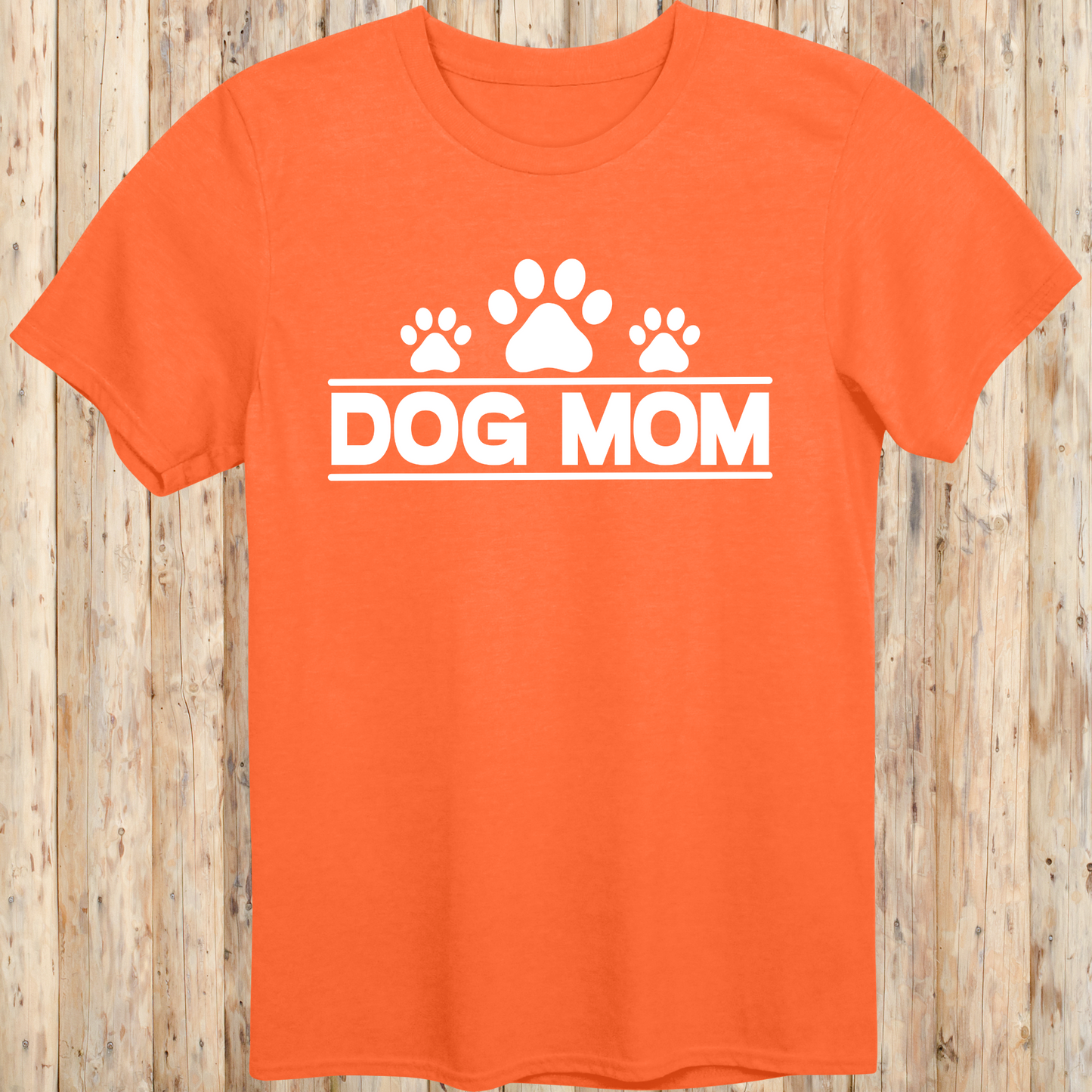 Orange unisex t-shirt with bold text that reads 'Dog Mom', ideal for pet parents, dog lovers, and animal rescue supporters