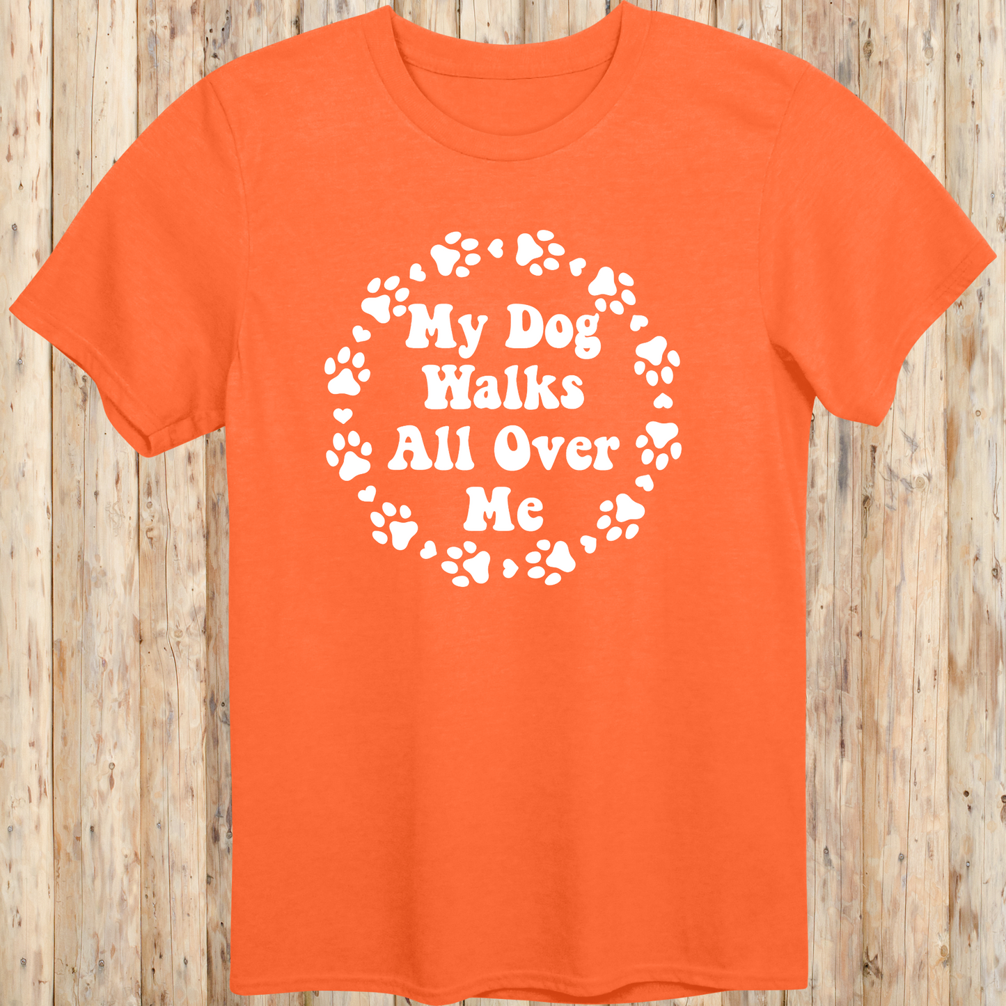 unisex orange t-shirt for dog lovers says my dog walks all over me paw prints circle