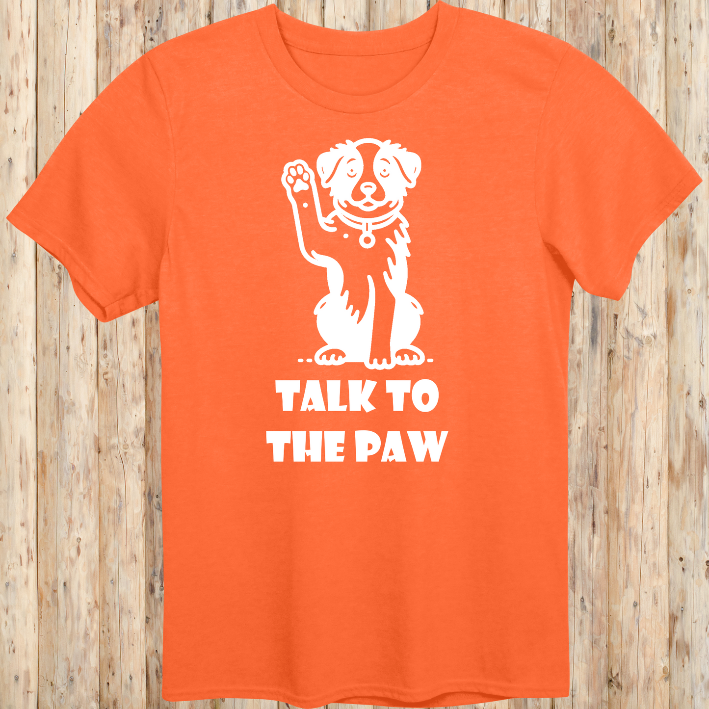 Orange unisex t-shirt with text that says 'Talk to the Paw', ideal for dog lovers and pet parents with a fun, sassy style