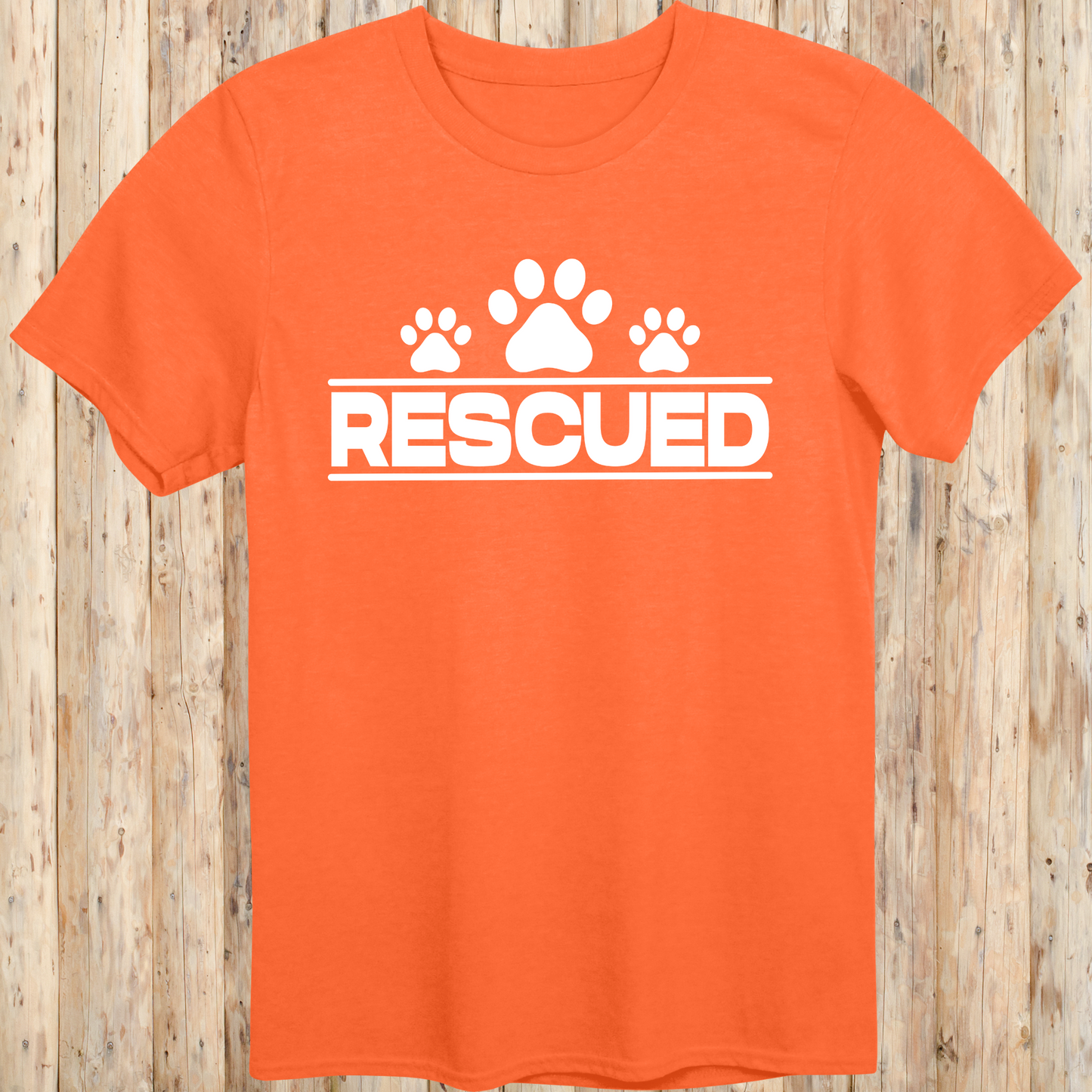 Orange unisex t-shirt with text that reads 'Rescued', ideal for rescue dog adopters and animal welfare supporters