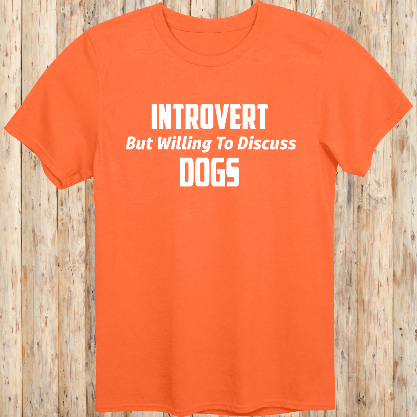 orange unisex t-shirt with white text that reads 'Introvert But Willing to Discuss Dogs', 