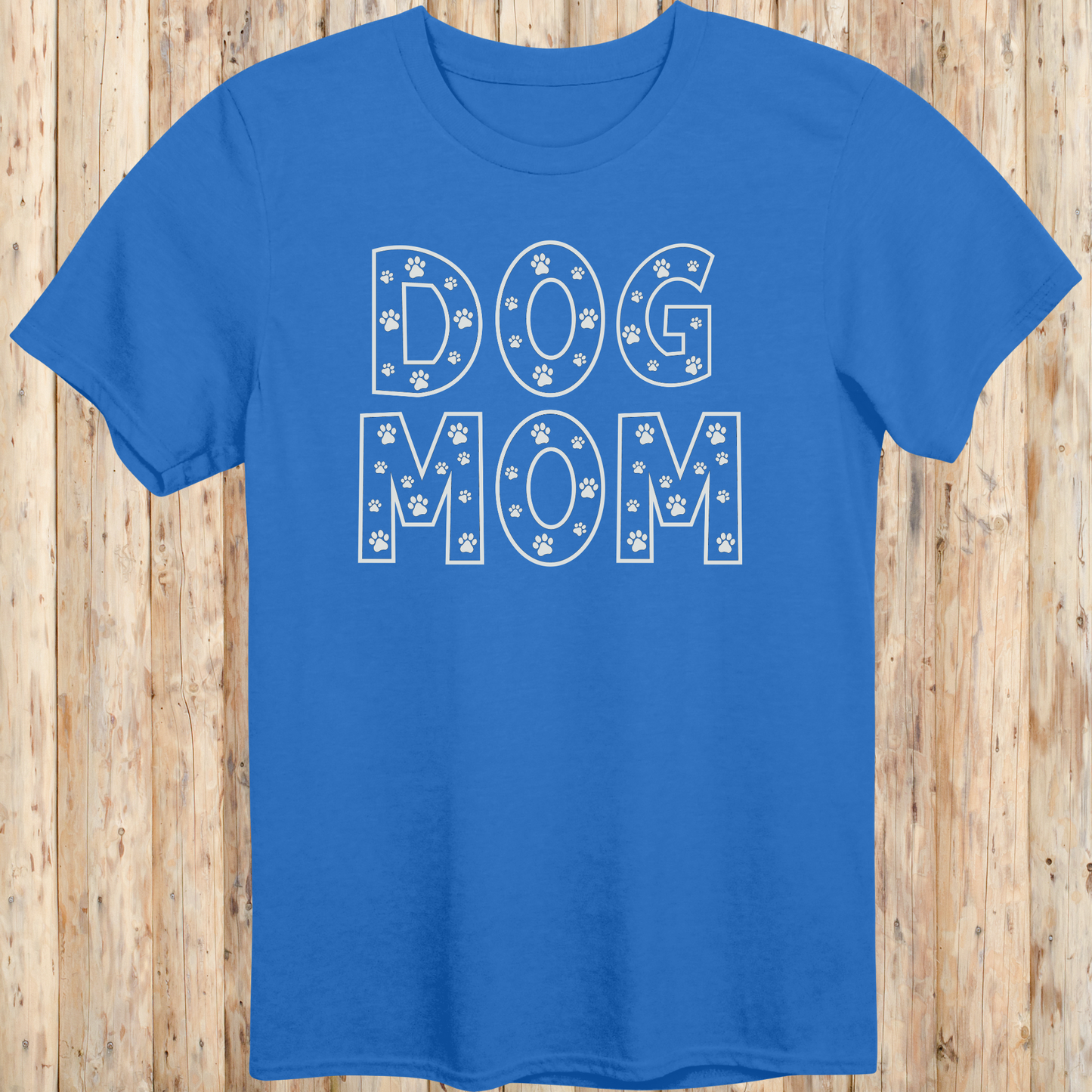 Royal blue unisex t-shirt with the words 'Dog Mom' in white text and small paw print accents, ideal for pet moms and dog lovers