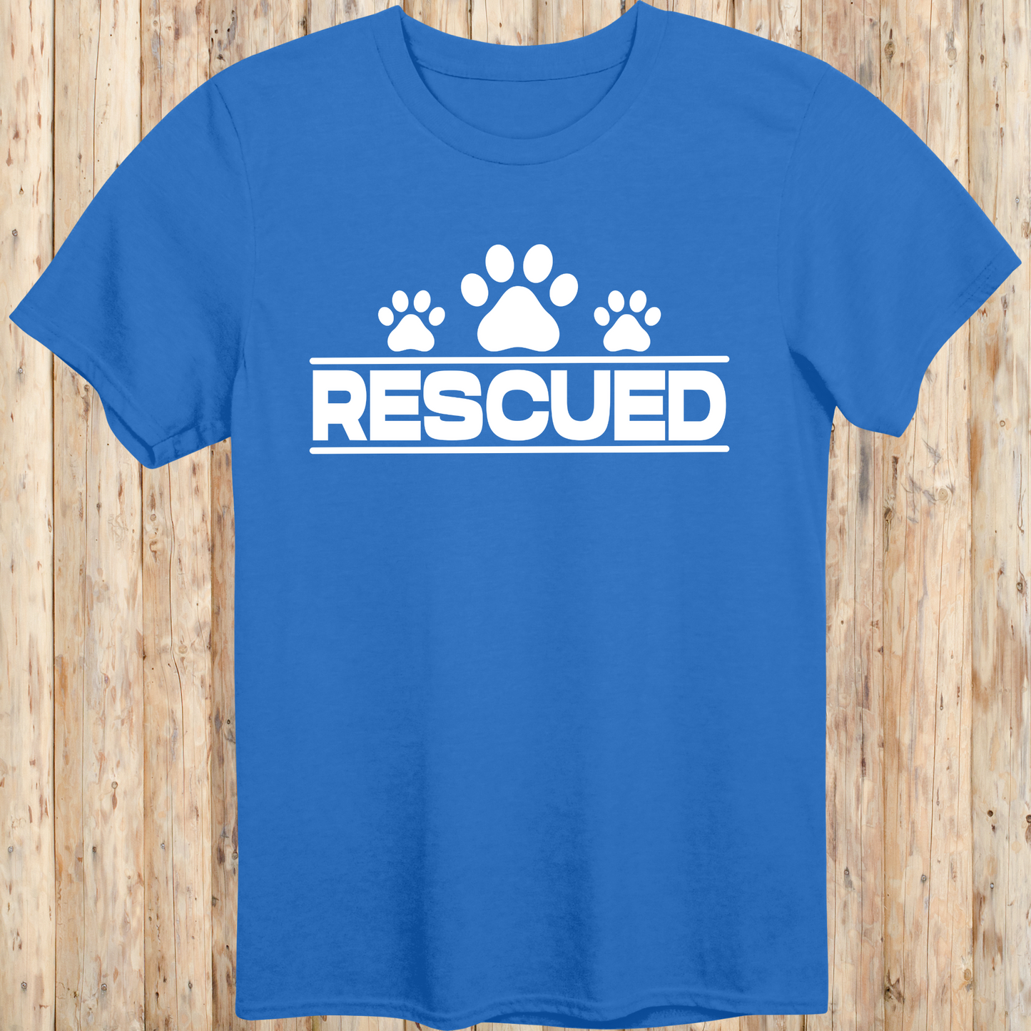 Royal blue unisex t-shirt with text that reads 'Rescued', ideal for rescue dog adopters and animal welfare supporters