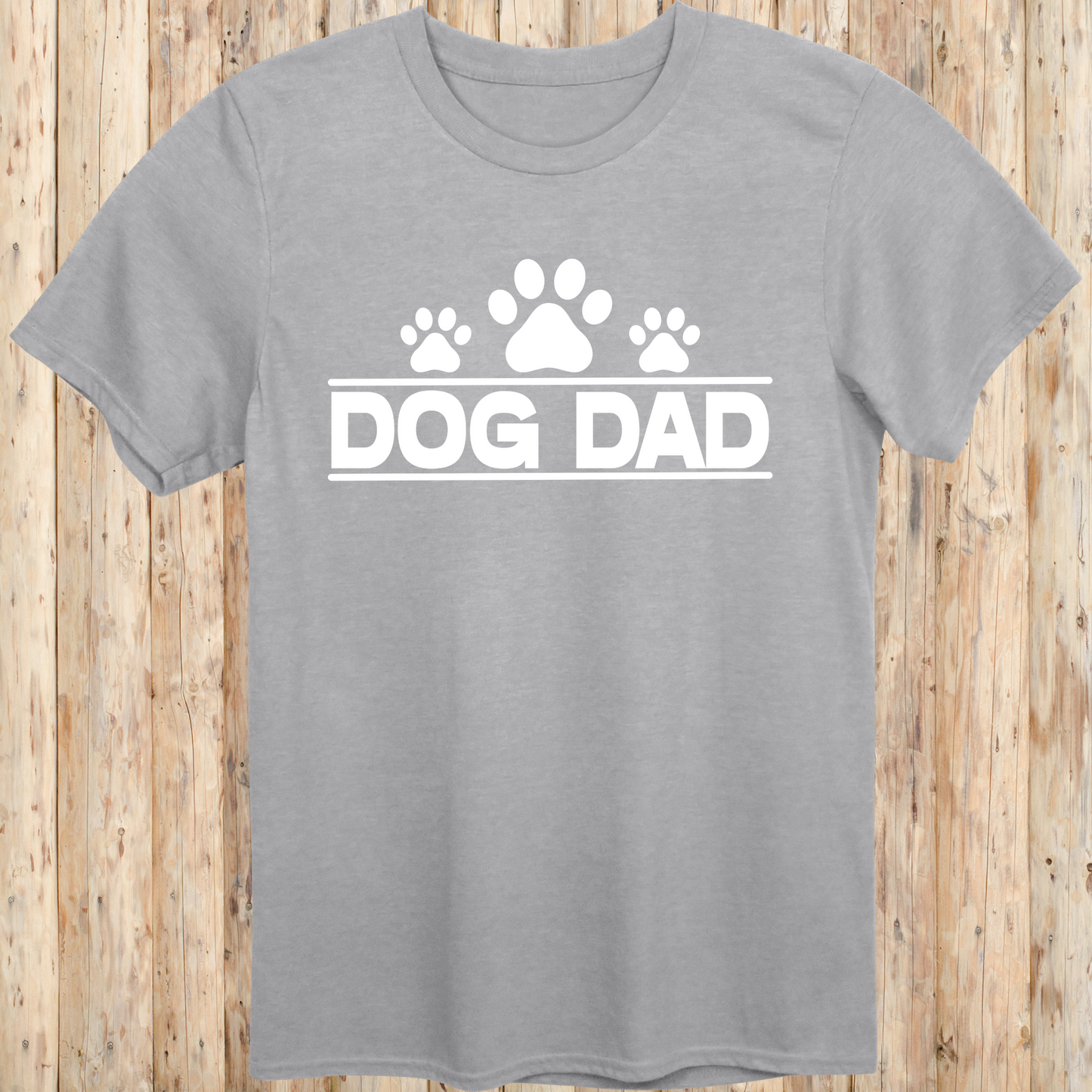 Sport grey unisex t-shirt with bold text that says 'Dog Dad', perfect for fathers, pet owners, and dog lovers