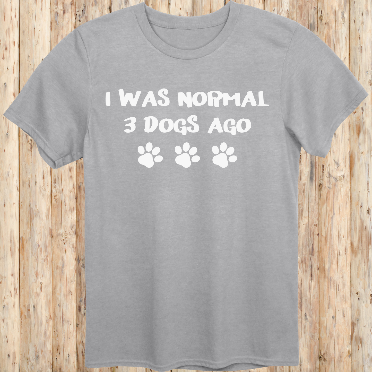 Sport grey unisex t-shirt with text that says 'I Was Normal 3 Dogs Ago', ideal for dog lovers and multiple pet owners