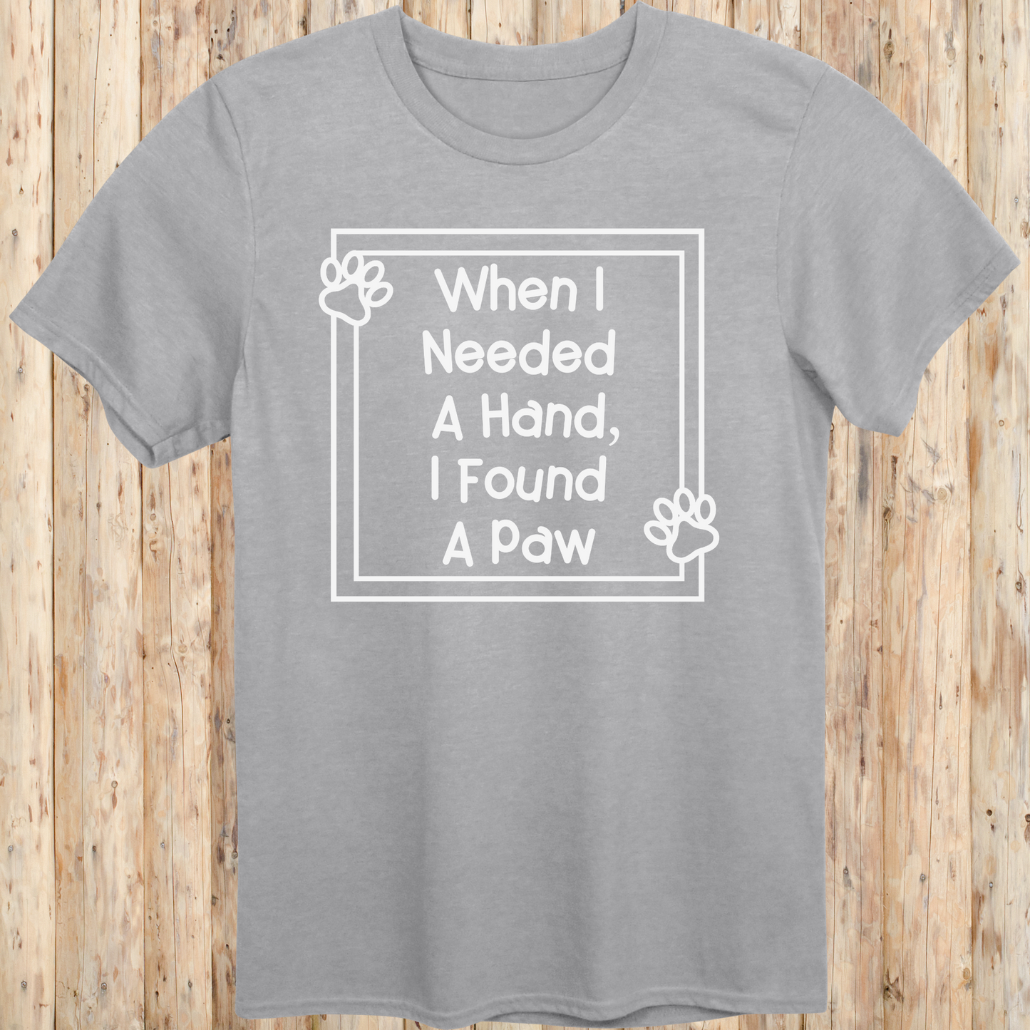 Sport grey unisex t-shirt with text that reads 'When I Needed a Hand I Found a Paw', ideal for dog lovers and rescue pet adopters