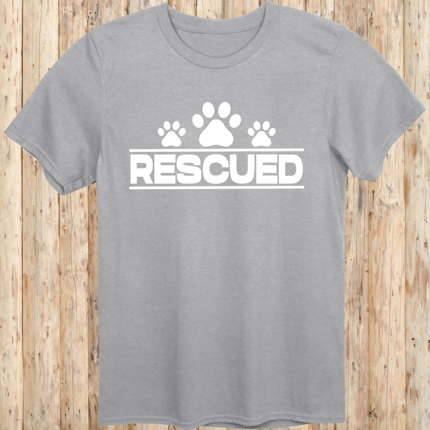 Sport grey unisex t-shirt with text that reads 'Rescued', ideal for rescue dog adopters and animal welfare supporters