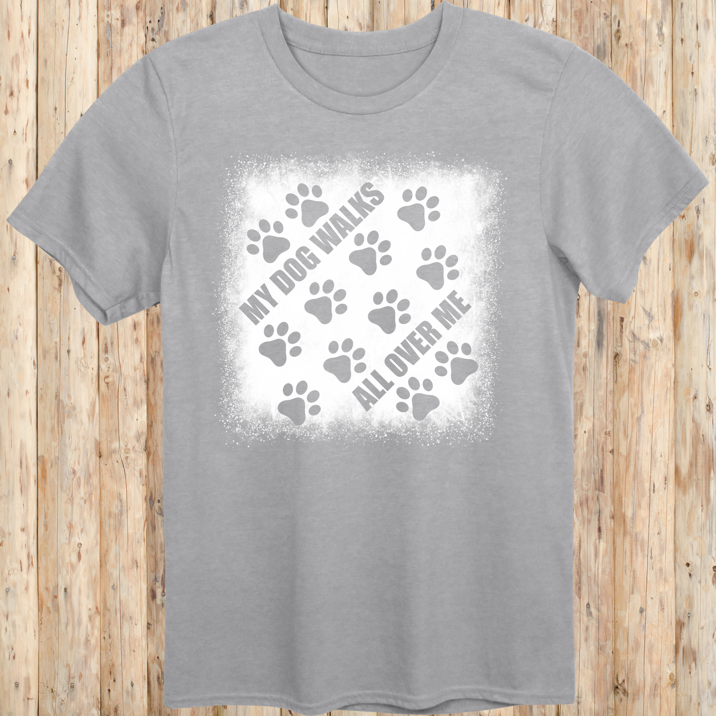 Sport grey unisex t-shirt with paw prints and the phrase 'My Dog Walks All Over Me' printed on the front for men women adults and humans.