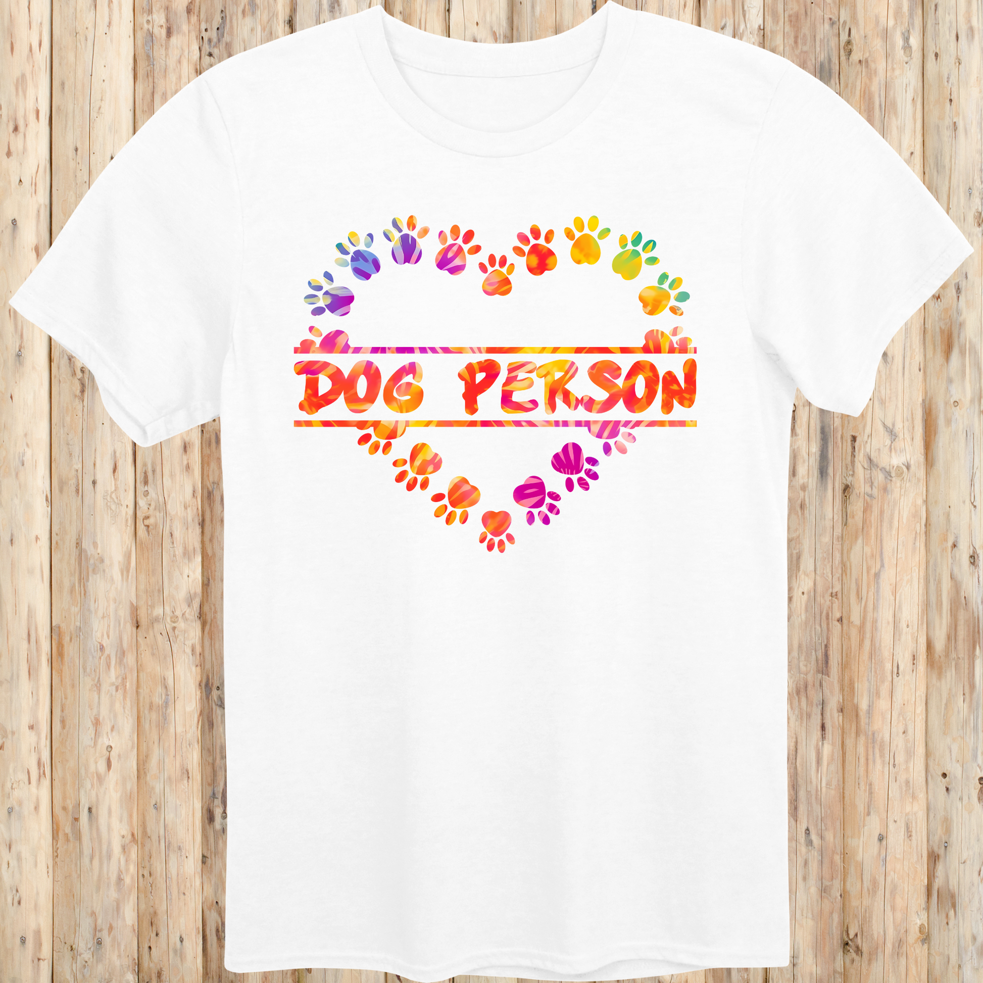 White unisex t-shirt with the words 'Dog Person' and a colorful heart-shaped paw print design, perfect for dog lovers and pet parents