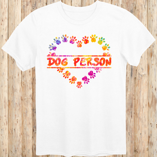 White unisex t-shirt with the words 'Dog Person' and a colorful heart-shaped paw print design, perfect for dog lovers and pet parents