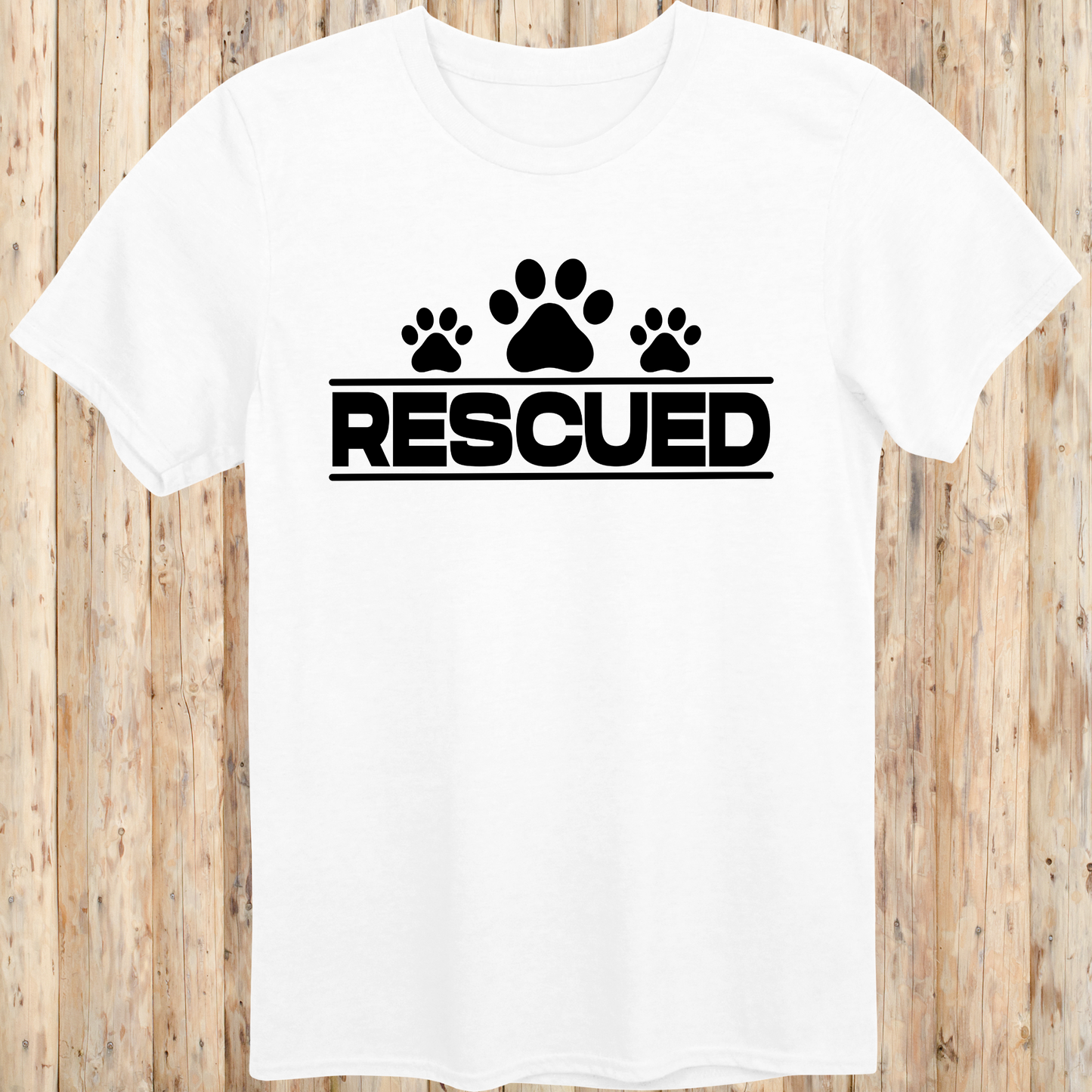 White unisex t-shirt with text that reads 'Rescued', ideal for rescue dog adopters and animal welfare supporters