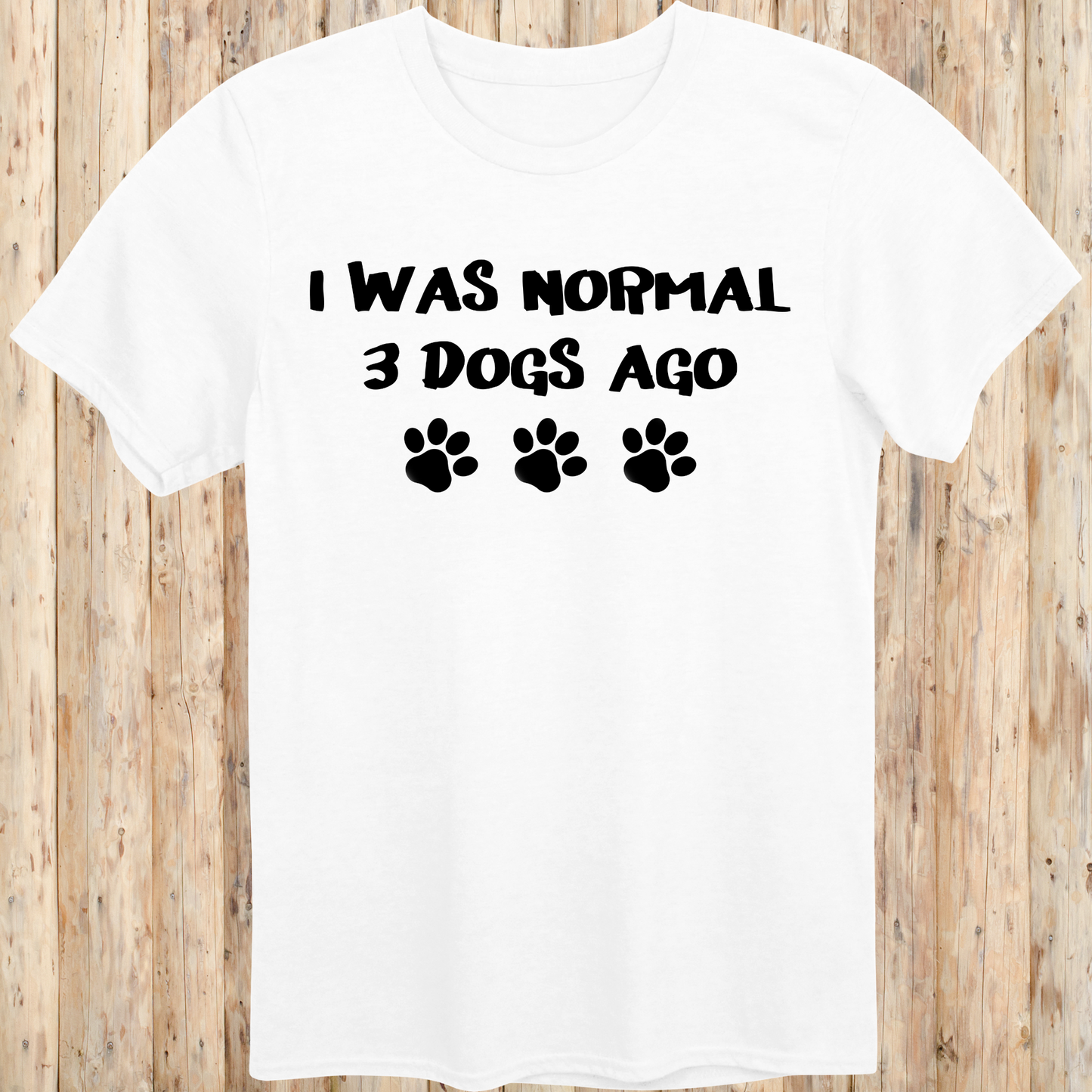 White unisex t-shirt with text that says 'I Was Normal 3 Dogs Ago', ideal for dog lovers and multiple pet owners